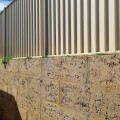 What do you do with gap between fence and retaining wall?