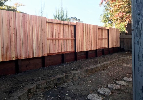What is the difference between a fence and a retaining wall?